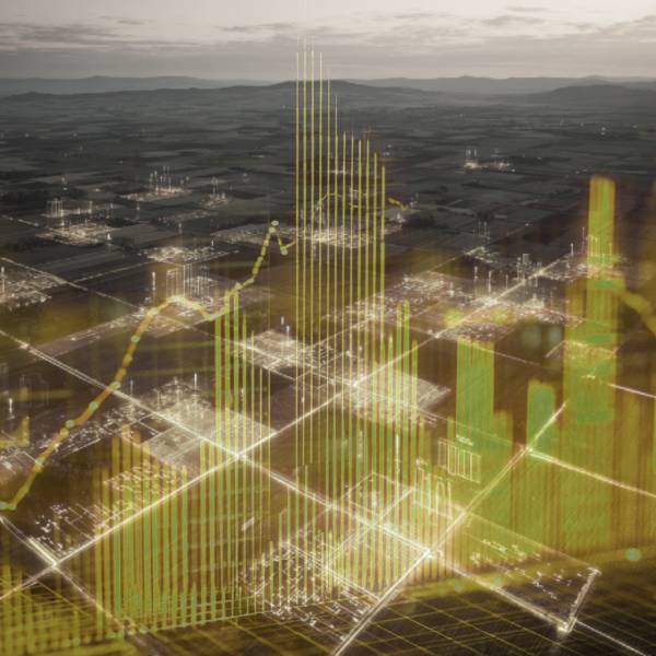Aerial view of farm fields overlaid with glowing yellow and green bar graphs and grid lines, symbolizing block-level profitability insights and real-time agricultural data analysis.